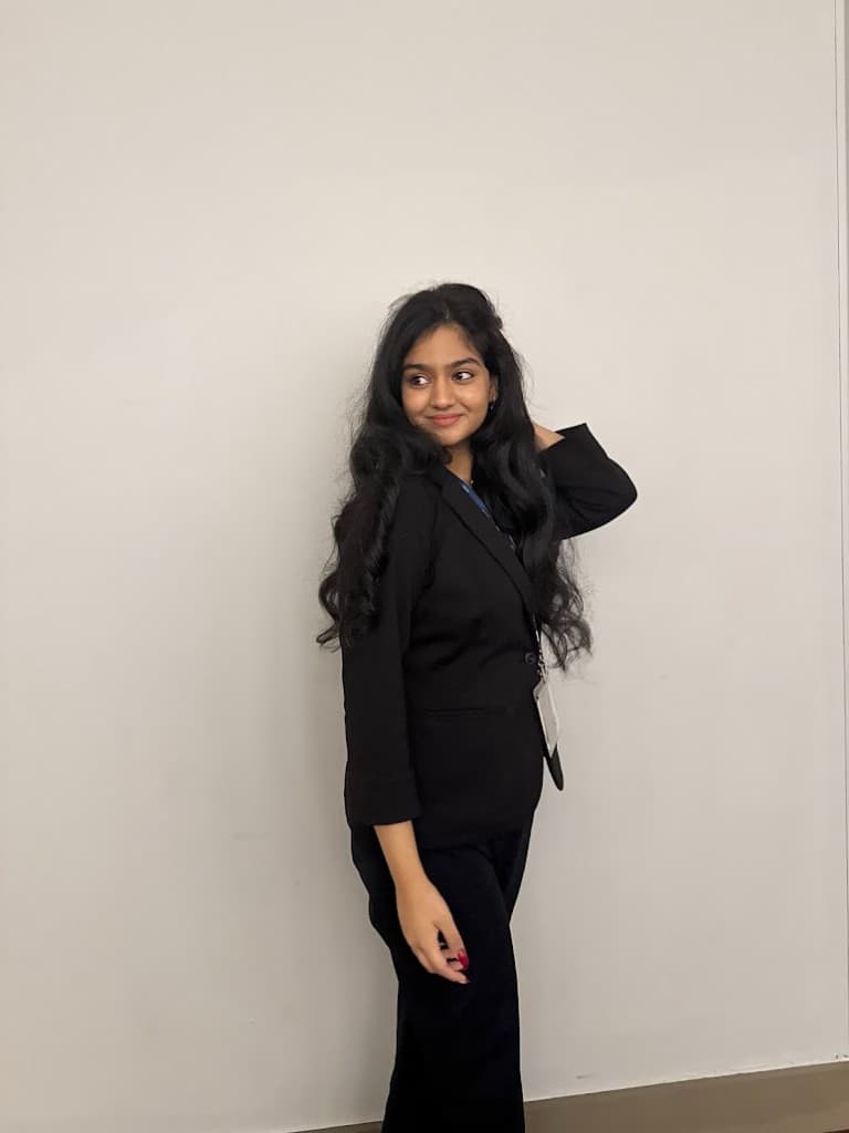 Headshot of Manasvi Patwari, Co-Founder of NeuroSol, smiling outdoors in natural light against a light stucco wall